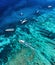 Boats on the water surface from top view. Azure water background from drone. Summer seascape from air.