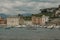 boats and yachts in the bay of Silence, Baia di Silenzio in Sestre-Levante, Liguria, Italy across the buildings, mountains,