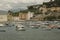 Boats and yachts floating in the bay of Silence, Baia di Silenzio in Sestre-Levante, Liguria, Italy across the colorful buildings,