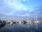 Boats and yachts in a marina with reflected water,modern water transport, summertime vacation, luxury lifestyle and wealth concept
