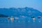 Boats and yachts stand in the sea against the backdrop of the mountains