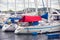 Boats and yachts tied up with ropes to a pier