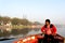 boatsman oarsman rowing into the middle of a river early morning