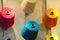 bobbins with multicolored threads for sewing. Needlework, sewing and tailoring concept. Fabric and textile industry