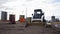Bobcat skid-steer loader and mini road roller during roadwork. Paving roller machine at construction site for asphalt pavement. Ð¡