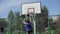 Bobruisk, Belarus - 12 August 2019: Slow motion. Happy basketball player leading and passing ball during street