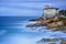 Boccale castle landmark on cliff rock and sea. Tuscany, Italy. Long exposure photography.