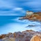 Boccale castle landmark on cliff rock and sea. Tuscany, Italy. Long exposure photography.