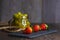 Bodegon fruit, fresh strawberries on slate plate with glass jar with fresh grapes on aged basis