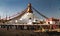 Bodhnath stupa with tourists, buddhist monks and pigeons