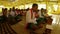 Bodo Assam Local Tribe men and women sing a prayer and play musical ancient instruments in the temple in national costumes sitting