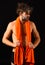 Body care. Man with orange towel on neck ready to take shower. Macho attractive nude guy black background. Man bearded