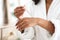 Body Care. Unrecognizable Black Woman Applying Organic Moisturising Serum On Hands Skin