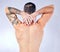 Body care, wellness and back view of a man in a studio with muscles, tattoos and fit body. Fitness, warm up and