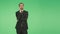 Body language. a man in a business suit on a green background