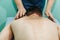 Body massage at physiotherapist office young man getting professional spine and back treatment