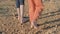 Body part of children`s feet. little refugees standing on a dirt road barefoot with no shoes on close up