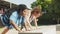 Body positive women doing press-ups from bench on sports ground