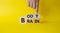 Body vs Brain symbol. Businessman hand points at turned wooden cubes with words Brain and Body. Beautiful yellow background.