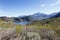 Body of water with snow on the mountains