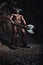 The bodyart man angry minotaur with axe in cave