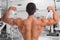 Bodybuilder bodybuilding flexing muscles posing gym back biceps