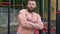 Bodybuilder demonstrates muscles. Young bearded athletic bodybuilder plays sports outdoors