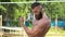 Bodybuilder demonstrates muscles. Young bearded athletic bodybuilder plays sports outdoors