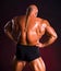 Bodybuilder demonstrating muscles of the back and arms