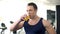 Bodybuilder drinking fresh orange juice, balanced fitness nutrition, workout