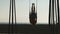 A bodybuilder exercises on roman rings at Venice Beach