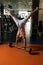 Bodybuilder Exercising Handstand Push-Ups On Barbell In Gym