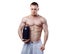 Bodybuilder holding a black plastic jar with whey