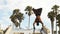 Bodybuilder performs a handstand at Muscle Beach