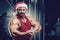 Bodybuilder in Santa Claus costume in gym