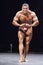 Bodybuilder shows his most muscular pose on stage