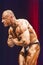 Bodybuilder shows most muscular pose on stage in championship