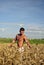 Bodybuilder standing waist-deep in the field