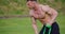 Bodybuilder using resistance band for training outdoors