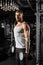 Bodybuilding. Bearded man standing at gym with dumbbells motivated