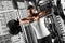 Bodybuilding. Bearded man standing leaning on barbell at gym looking forward sassy