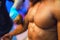 Bodybuilding competition backstage: contestant being oiled and fake tan applied to skin