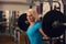 Bodybuilding. Strong fit woman exercising with barbell. girl doing squats with big weights