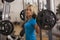 Bodybuilding. Strong fit woman exercising with barbell. girl lifting weights in gym