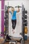 Bodybuilding. Strong fit woman exercising in a gym - doing pull-ups.