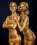 Bodypaint. Two Women Painted Gold. Carnival