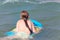 Bodysurfing - young girl surfing in the Mediterranean Sea, Spain