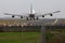 Boeing 747 jumbo jet landing on runway.