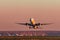 Boeing 777-300er Emirates Airlines takes off at sunset