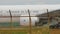 Boeing 777 taxiing along the airport fence